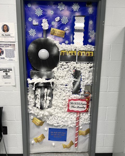 a classroom door decorated to look like a steam engine on a snowy night background
